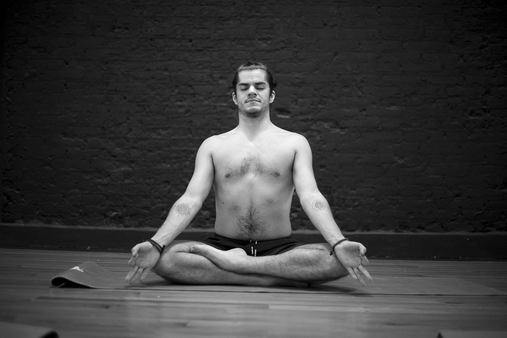 Male sitting cross legged meditating