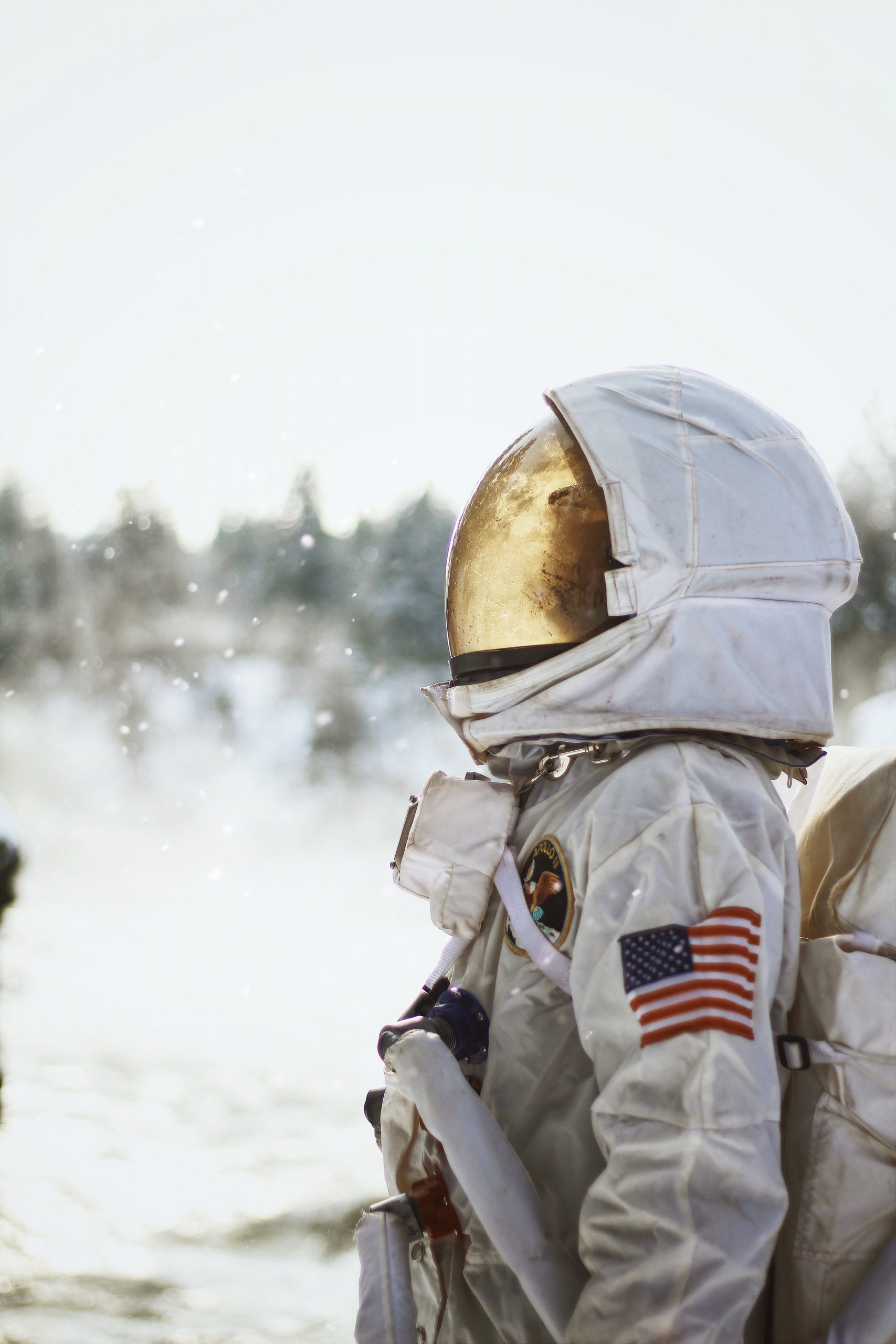 Astronaut with mask on with American flag on arm