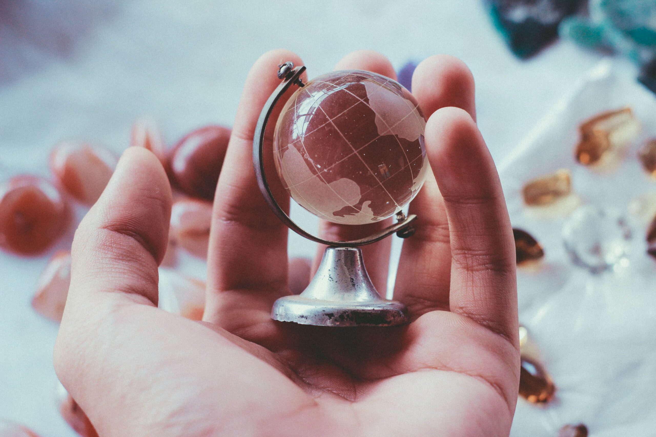 Hand holding a small glass globe