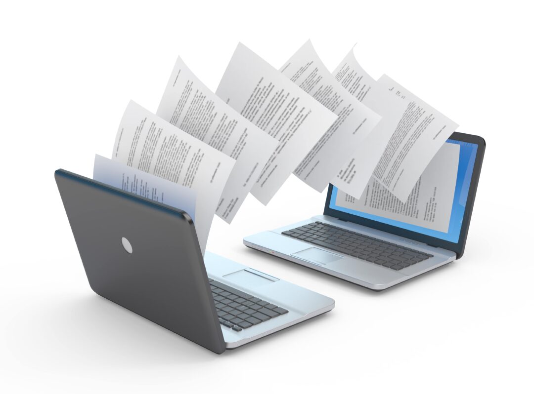 Documents being transferred between laptops for translation