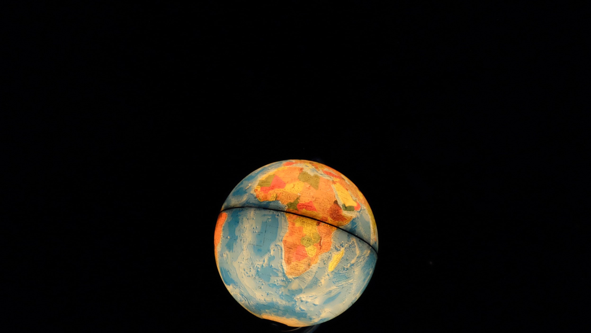 Lit up globe with a black background